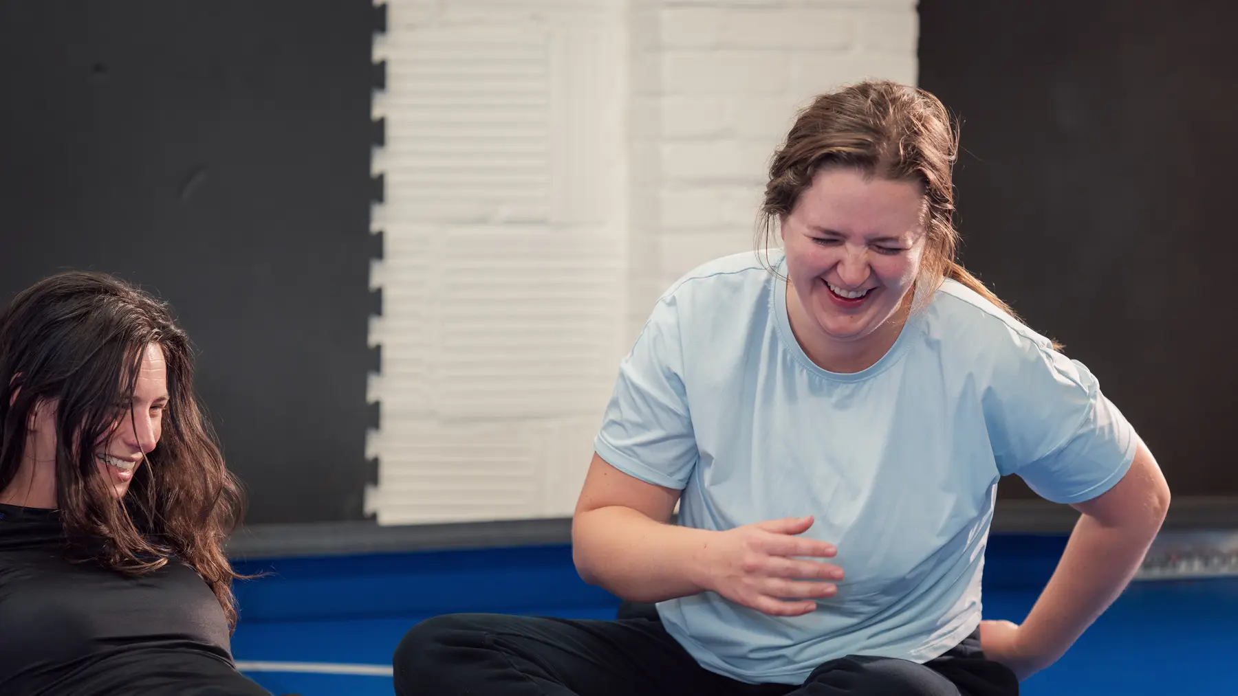 Training partners sharing a laugh on the mat