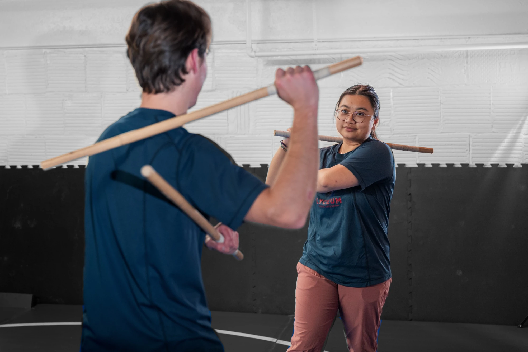 Lyceum partners practicing Kali with training sticks