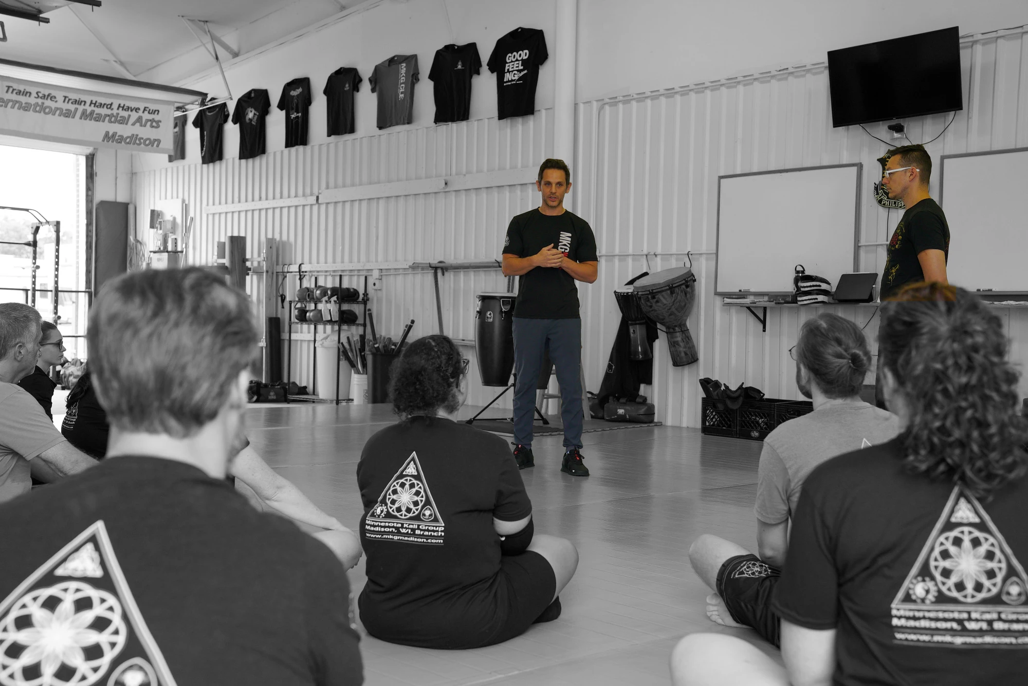 A martial arts group watching a demonstration
